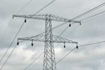 High voltage power line tower with pulleys during cable installation