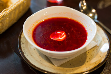 beetroot soup with sour cream in bowl.