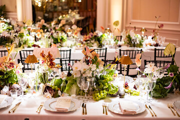 Elegant Wedding Reception with Floral Centerpieces and Golden Light