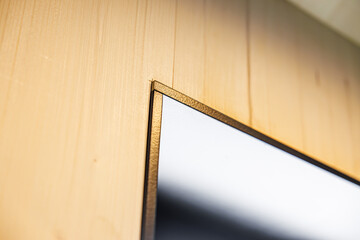 Corner Detail of Golden Frame on Wooden Wall