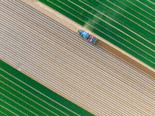 In spring, farmers use farm machinery to grow peanuts