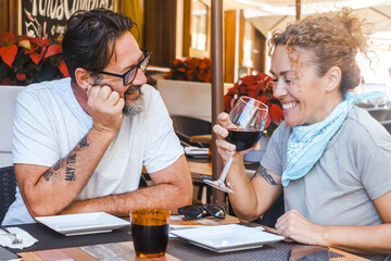 Happy couple enjoying meal at restaurant – romantic date, vacation mood, weekend vibes, relationship and quality time concept
