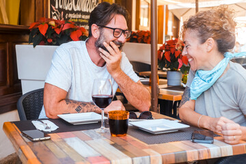 Happy couple enjoying meal at restaurant – romantic date, vacation mood, weekend vibes, relationship and quality time concept