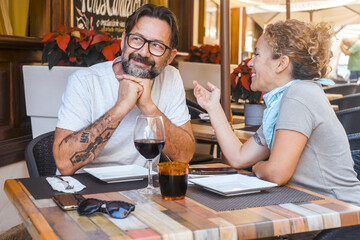 Happy couple enjoying meal at restaurant – romantic date, vacation mood, weekend vibes, relationship and quality time concept
