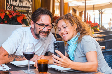 Happy couple enjoying meal at restaurant – romantic date, vacation mood, weekend vibes, relationship and quality time concept