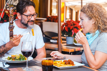 Happy couple enjoying meal at restaurant – romantic date, vacation mood, weekend vibes,...