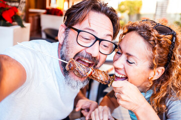 Happy couple enjoying meal at restaurant – romantic date, vacation mood, weekend vibes,...