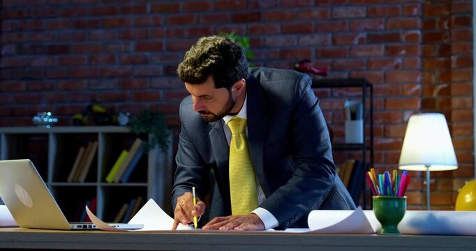 Indian architect drafting drawing at office desk, Asian professional draftsman working on blueprint and technical plans, symbol of creativity, precision, architectural design, planning, engineering