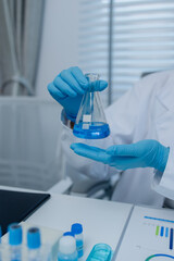 a female chemist is testing various liquid compounds in a lab, a scientist is doing research on the development of science in a lab, laboratory, test tube, scientific