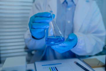 a female chemist is testing various liquid compounds in a lab, a scientist is doing research on the...