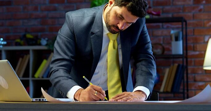 Indian architect drafting drawing at office desk, Asian professional draftsman working on blueprint and technical plans, symbol of creativity, precision, architectural design, planning, engineering