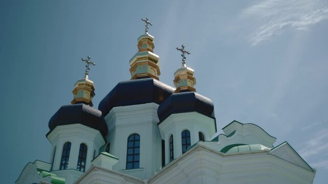 Golden Domes and Blooming Garden at Kyiv-Pechersk Lavra Skete"
