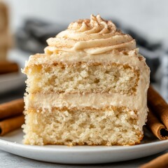 Mouthwatering Snickerdoodle Cake Slice with Creamy Cinnamon Frosting and Decorative Cinnamon Sticks