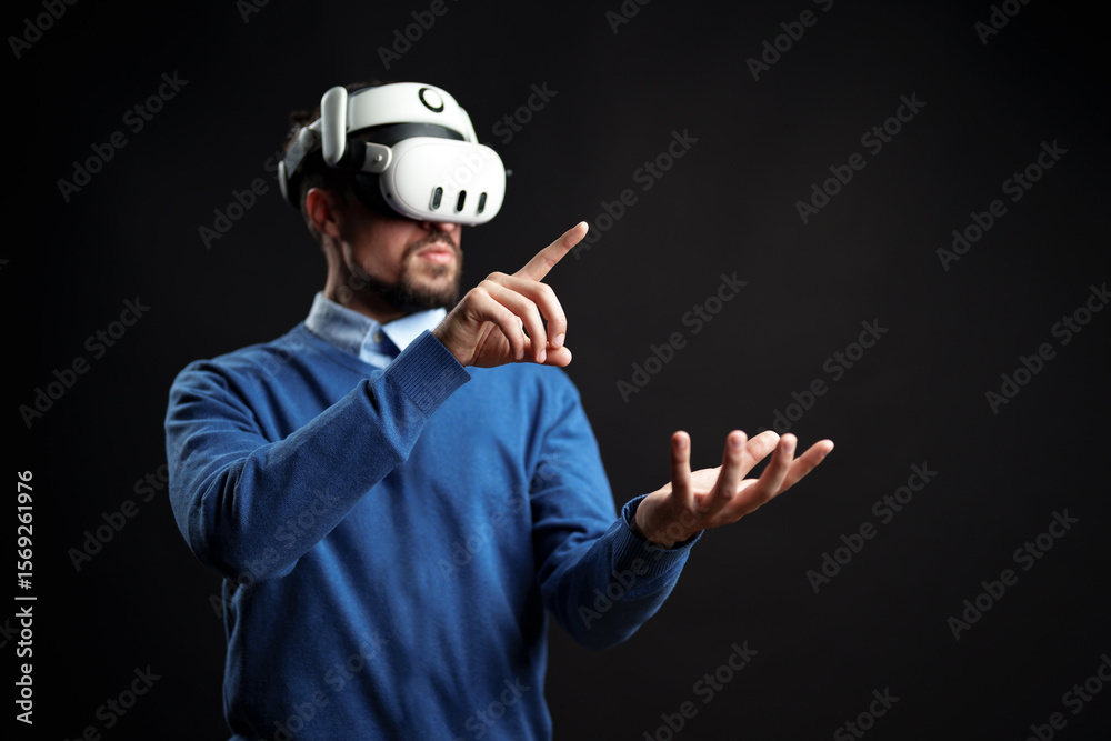 Poster virtual reality experience with a man interacting in a dark setting using advanced technology