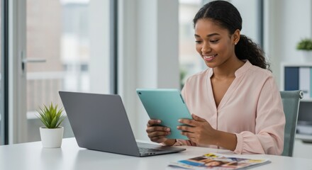Fototapeta premium Photo of young woman works on laptop and tablet