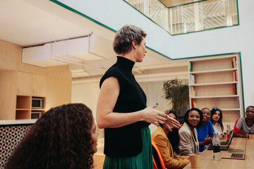 Group of diverse professionals engaged in a lively agency office meeting