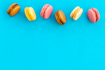 sweet dessert pattern with macarons on blue background flat lay mockup