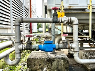 pipes and valves, Close-up of stainless steel industrial piping system with valves and control components in a factory. Used in fluid transfer, process engineering, and manufacturing environments.