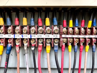 Close-up of color-coded electrical wiring and terminal blocks in an industrial control cabinet....