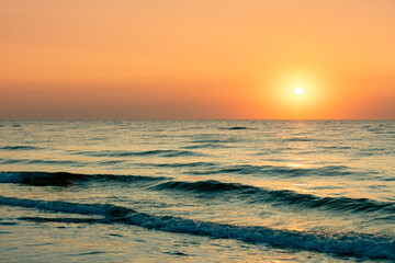 Seascape in the early morning. Beautiful orange sunrise over the sea