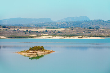 Mountain lake on a sunny day. Embalse de la Pedrera Reservoir, Alicante, Spain