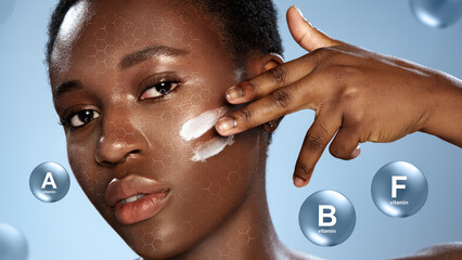Woman applying skincare product with visible vitamins A, B, and F highlighted in background