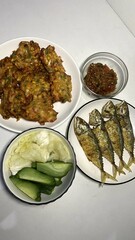 Delicious Indonesian Cuisine with Fried Fish and Vegetables