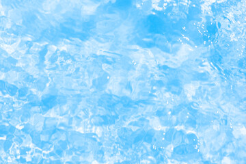 Blue water with ripples on the surface. Defocus blurred transparent blue colored clear calm water surface texture with splashes and bubbles. Water waves with shining pattern texture background.