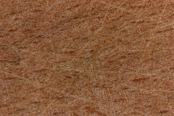 Close-up of a textured brown wood surface with grain pattern.