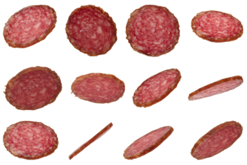 Many thin slices of smoked salami sausage scattered on isolated background