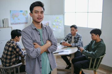 Young Man Standing Confidently With Arms Crossed Looking At The Camera