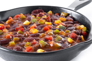 Mexican chilli beans with vegetables in iron pan isolated on white background. Close up