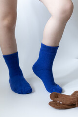 Baby feet in blue socks on a white background