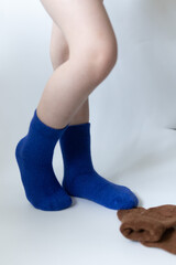 Baby feet in blue socks on a white background