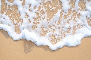Ocean Foam Gently Rolling onto Warm Beach Sand