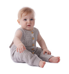 Cute little baby in knitted romper on white background