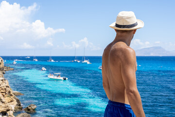 Man enjoying sea view from coastal cliff in Favignana, Sicily