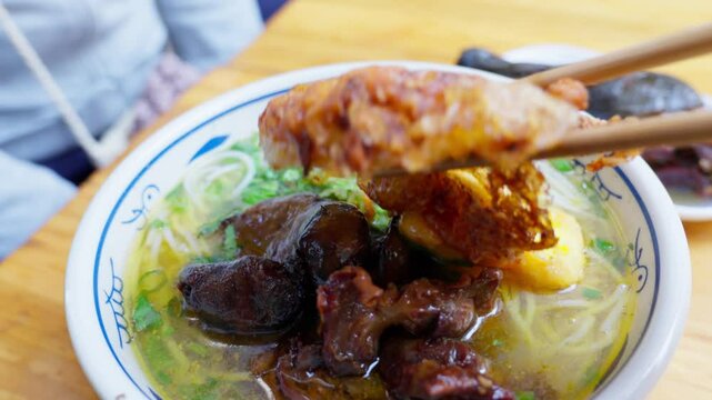 A bowl of Yunnan-style rice noodles topped with native chicken slices in clear broth&mdash;highlighting savory warmth, regional texture, and the wholesome charm of ethnic Chinese street cuisine.