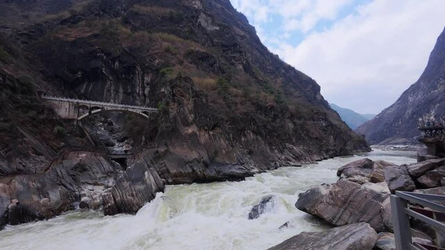 A time-lapse of Tiger Leaping Gorge in Shangri-La captures steep cliffs flanking a powerful river&mdash;revealing cloud-shrouded skies, turbulent waters, and the awe-inspiring scale of one of China&rsquo;s deepes