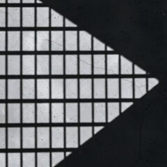 Geometric shadows cast on a textured, aged wall, creating a pattern.