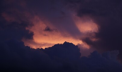 Toma de lejos de unas bellas nubes de color naranja o rojo en un cielo de color azul durante el atardecer