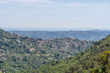 Scenic hilltop view over lush valleys and distant Mediterranean horizon — French Riviera landscape