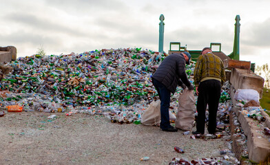 Efforts to clean up a waste site by two individuals collecting recyclable materials near a city...