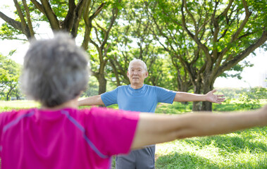 Happy Asian Senior Couple breathing in fresh  air in park during meditation practice