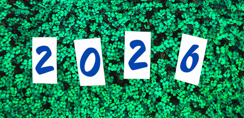 Celebration of a new year with 2026 displayed amidst vibrant green foliage