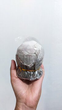 A hand holds an asin tibuok which is a rare Filipino artisanal sea salt which is a local product from Bohol, Philippines that celebrates heritage and culture