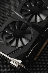 Black Gaming GPU with Dual Cooling Fans on Mesh Surface