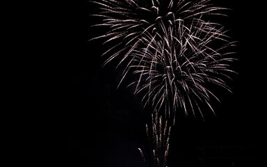 dark night sky with distant fireworks burst