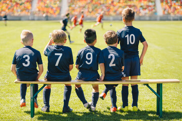 Youth Soccer Team Watching Match from Sidelines. Kids in Uniform Waiting to Play During Competitive Football Game Tournament. School Youth Soccer League Games
