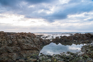 Seascape image taken on the South African coastline with rocks in foreground